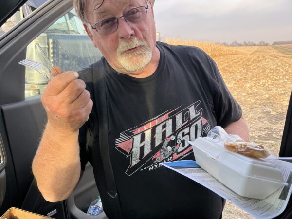 Gary's brother, Richard Paplow, getting his supper from the pickup while helping out in Fulda, Minnesota. 