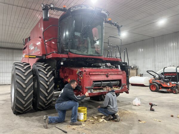 Paul and Jason changing over the combine to accommodate a Case IH corn head. 